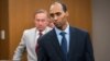 FILE - Former Minneapolis police officer Mohamed Noor walks to the podium at Hennepin County District Court in Minneapolis. The Minnesota Supreme Court has reversed the third-degree murder conviction of Noor who fatally shot an Australian woman in 2017.