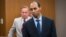 FILE - Former Minneapolis police officer Mohamed Noor walks to the podium at Hennepin County District Court in Minneapolis. The Minnesota Supreme Court has reversed the third-degree murder conviction of Noor who fatally shot an Australian woman in 2017.