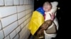 Ukrainian serviceman Yevhen Liashenko hugs his wife, Kateryna, after returning from captivity during a prisoner exchange between Russia and Ukraine, in Ukraine, Dec. 30, 2024.