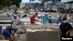 People construct burial vaults in the Angela Maria Canalis cemetery as the coronavirus disease (COVID-19) overwhelms sanitary authorities, in Guayaquil, Ecuador April 8, 2020. REUTERS/Vicente Gaibor del Pino NO RESALES. NO ARCHIVES