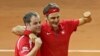 Swiss coach Severin Luthi (L) and Switzerland's Roger Federer celebrate after Federer defeated France's Richard Gasquet in the Davis Cup final in Lille, northern France, Nov. 23, 2014.