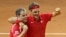 Swiss coach Severin Luthi (L) and Switzerland's Roger Federer celebrate after Federer defeated France's Richard Gasquet in the Davis Cup final in Lille, northern France, Nov. 23, 2014.