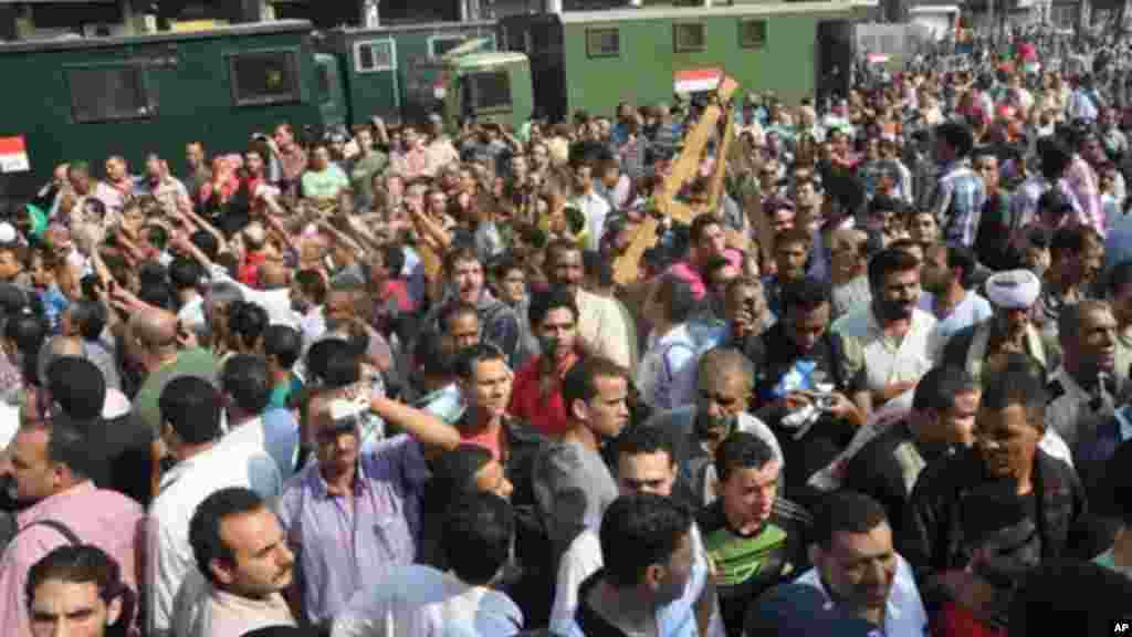 Egyptians security forces escort an Islamist supporter of the Muslim Brotherhood out of the al-Fatah mosque, Aug. 17, 2013.