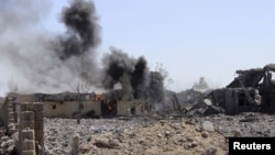 Smoke billows from a storage building belonging to the education ministry's printing press corporation after it was hit by a Saudi-led airstrike in Yemen's northwestern city of Saada, June 2, 2015. 