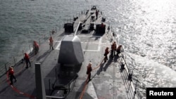 FILE - Taiwan navy soldiers take part during a joint military drill on a Kidd-class destroyer outside a naval base in Kaohsiung, Taiwan.