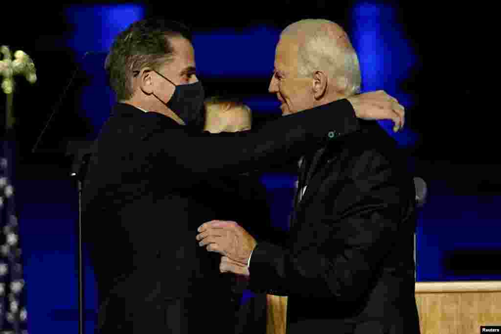 Democratic 2020 U.S. presidential nominee Joe Biden embraces his son Hunter Biden at an election rally, after the news media announced that Biden has won the 2020 U.S. presidential election.