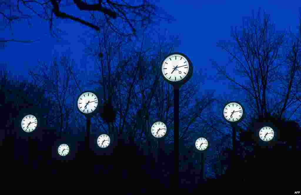 Clocks of the art installation &#39;Zeitfeld&#39; (time field) by German artist Klaus Rinke are seen in Duesseldorf, western Germany. Clocks in Germany will be changed to daylight saving time and turned forward one hour on 28 March, 2021.