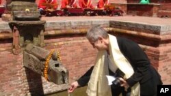 Ambassador Nancy J. Powell, Director General of the Foreign Service and Director of Human Resources, enjoying the water of Nag Bahal Hiti, a traditional Nepalese water spout restored by the Ambassadors Fund for Cultural Preservation. (file)