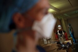 Medical staff tend to patients affected by COVID-19 virus in the ICU unit at the Ambroise Pare clinic in Neuilly-sur-Seine, near Paris, April 10, 2020.