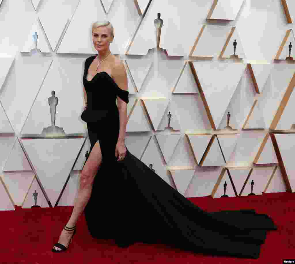 Charlize Theron in Dior and Tiffany &amp; Co. jewelry poses on the red carpet during the Oscars arrivals at the 92nd Academy Awards in Hollywood, Feb. 9, 2020. 