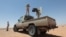 FILE - Libyan forces allied with the U.N.-backed government patrol to prevent Islamic State resurgence on the outskirts of Sirte, Libya, Aug. 4, 2017. A mass grave of suspected IS fighters was found in the area last week.