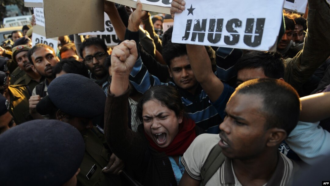 Indian residents hold placards and chant slogans as they take part in a protest against the alleged rape of a passenger by a driver working for the Uber taxi company in New Delhi, Dec. 7, 2014. 