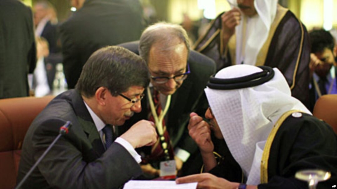 Turkey's FM Ahmet Davutoglu (L) confers with United Arab Emirates' (UAE) FM Sheikh Abdullah bin Zayed al-Nahyan during the Friends of Syria Conference in Tunis, February 24, 2012