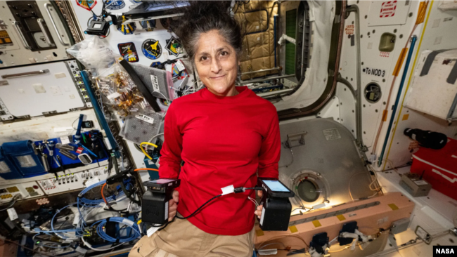 NASA astronaut Suni Williams displays portable carbon dioxide monitors aboard the International Space Station. (NASA)