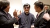 In this photo released by the U.S. Embassy Beijing Press Office, blind lawyer Chen Guangcheng is wheeled into a hospital by U.S. Ambassador to China Gary Locke, right, and an unidentified official at left, in Beijing, May 2, 2012. 