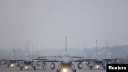 FILE PHOTO: 12 F-16V fighter jets perform an elephant walk during an annual New Year's drill in Chiayi