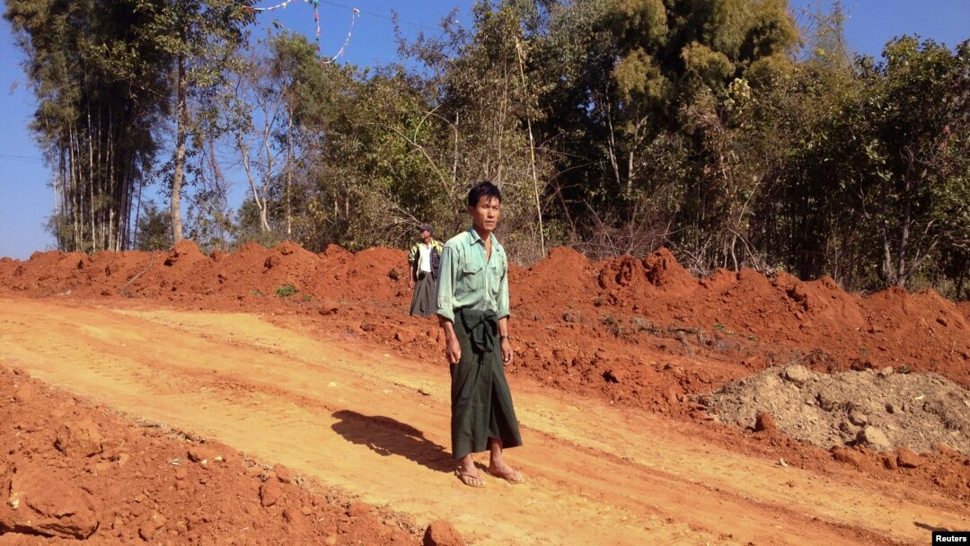 FIILE - Farmer U Thant Lwin stands on the site of his old paddy field, which has been ripped apart to make way for a gas pipeline to China, near the northeastern town of Pyin Oo Lwin, Burma, Jan. 2012.