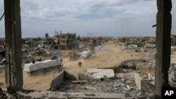 Humanitarian aid trucks enter through the Kerem Shalom crossing from Egypt into the Gaza Strip, in Rafah, Jan. 22, 2025.