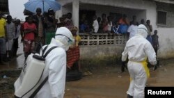 Trabajadores de la salud van casa por casa en la capital de Liberia para encontrar infectados por ébola.