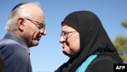 FILE —Nir (L), the brother of killed Israeli-Canadian peace activist Vivian Silver, greets Arab-Israeli Ghadir Hani a fellow peace activist from Acre, during her memorial service in Kibbutz Gezer, in central Israel on November 16, 2023.