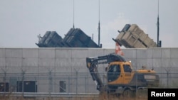 A truck moves past U.S. Army Patriot missile air defense artillery batteries at U.S. Osan air base in Osan, south of Seoul, April 5, 2013. 