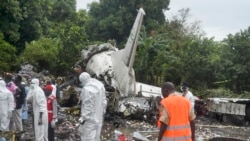 FILE- Responders pick through the wreckage of a cargo plane which crashed in the capital Juba, South Sudan Wednesday, Nov. 4, 2015. (AP Photo/Jason Patinkin).