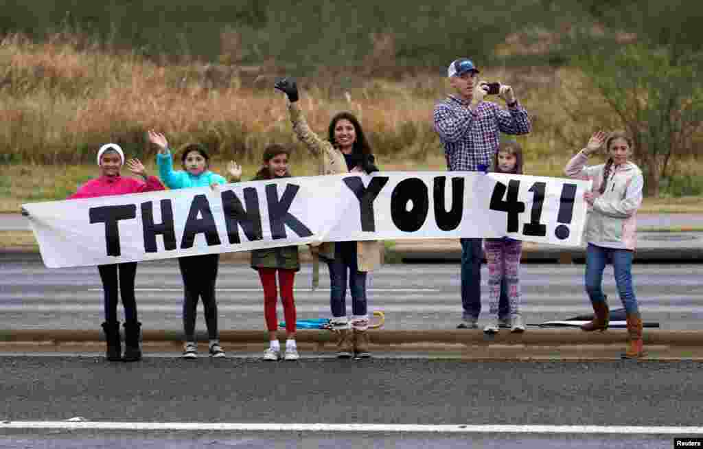 People pay their respects as the train carrying the casket of former President George H.W. Bush passes, Dec. 6, 2018, along the route from Spring to College Station, Texas. 