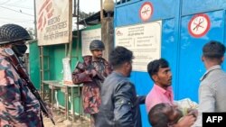 Local people carry a bullet wounded man for emergency aid at Médecins Sans Frontières (MSF) in Ukhia on February 4, 2024, after a military crackdown at the Bangladesh-Myanmar border.