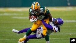 FILE - Minnesota Vikings' Harrison Hand stops Green Bay Packers' A.J. Dillon during the second half of an NFL football game, November 1, 2020, in Green Bay, Wis.