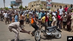 Supporters of opposition candidate Gen. Muhammadu Buhari's All Progressives Congress (APC) party celebrate by wheel-spinning motorcycles what they said was the senatorial win in Kano Central district of APC candidate Rabiu Musa Kwankwaso, in Kano, norther