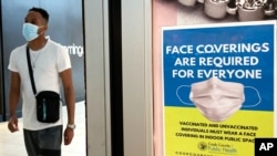 An information sign is displayed at a department store in Rosemont, Ill., Aug. 26, 2021.