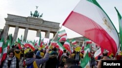 People demonstrate in support of protests across Iran, Jan. 6, 2018, in front of the Brandenburg Gate in Berlin.