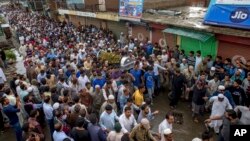 Kashmiri men carry the coffin of Shujaat Bukhari, the slain editor-in-chief of the Srinagar based newspaper Rising Kashmir during his funeral procession at Kreeri, 40 Kilometers (25 miles) from Srinagar, Indian controlled Kashmir, June 15, 2018. 