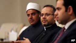 Monsignor Youannis Lahzi Gaid, personal secretary of Pope Francis, speaks to journalists as Prof. El-Mahrassawy, President of Al-Azhar University, and Judge Mohamed Mahmoud Abdel Salam, attend a roundtable discussion in Abu Dhabi, Feb. 3, 2020. 