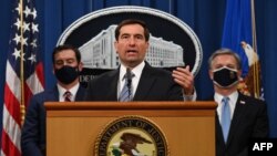 Assistant Attorney General John C. Demers (C) of the National Security Division, FBI Director Christopher Wray (R),and US Attorney for the Eastern District of Virginia G. Zachary Terwilliger (L) host a press conference on Operation Fox Hunt. 