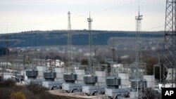 FILE - A mobile gas turbine power plant works to provide electricity in Stroganovka village outside Simferopol, Crimea, Nov. 22, 2015.