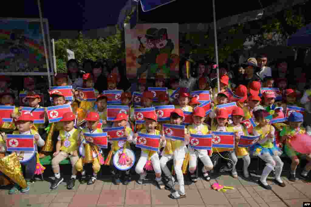 Children hold North Korea national flags at a joint friendship gathering to mark the 68th anniversary of an 'International Children's Day' event at the Kaeson Youth Park in Pyongyang.