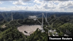 FILE - The Arecibo Observatory space telescope, which was damaged in August and in November from broken cables that tore holes in the structure, is seen in Arecibo, Puerto Rico, November 7, 2020. (UCF/Handout via REUTERS)