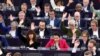 Members of the European Parliament raise their hands to vote during a plenary session at the European Parliament in Strasbourg, eastern France, on April 23, 2024.