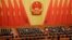 资料照：在北京人大会堂参加全国人大会议的中国官员起立唱国歌。（2019年3月15日）