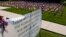 FILE - Some of the 660 American flags on display, illustrating the number of U.S. veterans who commit suicide each year, are seen by the banner on the church lawn of St. Peter's Reformed Church, in Zelienople, Pa., Aug. 30, 2019.
