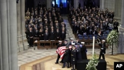 The flag-draped casket of former President Jimmy Carter is removed by honor guards after his state funeral at Washington National Cathedral in Washington, Jan. 9, 2025.