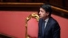 FILE - Italian Prime Minister Giuseppe Conte stands during a session in the Senate, the upper house of parliament, on the spread of coronavirus, in Rome, Italy, March 26, 2020.