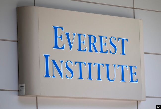 FILE - In this July 8, 2014 file photo, an Everest Institute sign is seen in an office building in Silver Spring, Md. (AP Photo/Jose Luis Magana, File)