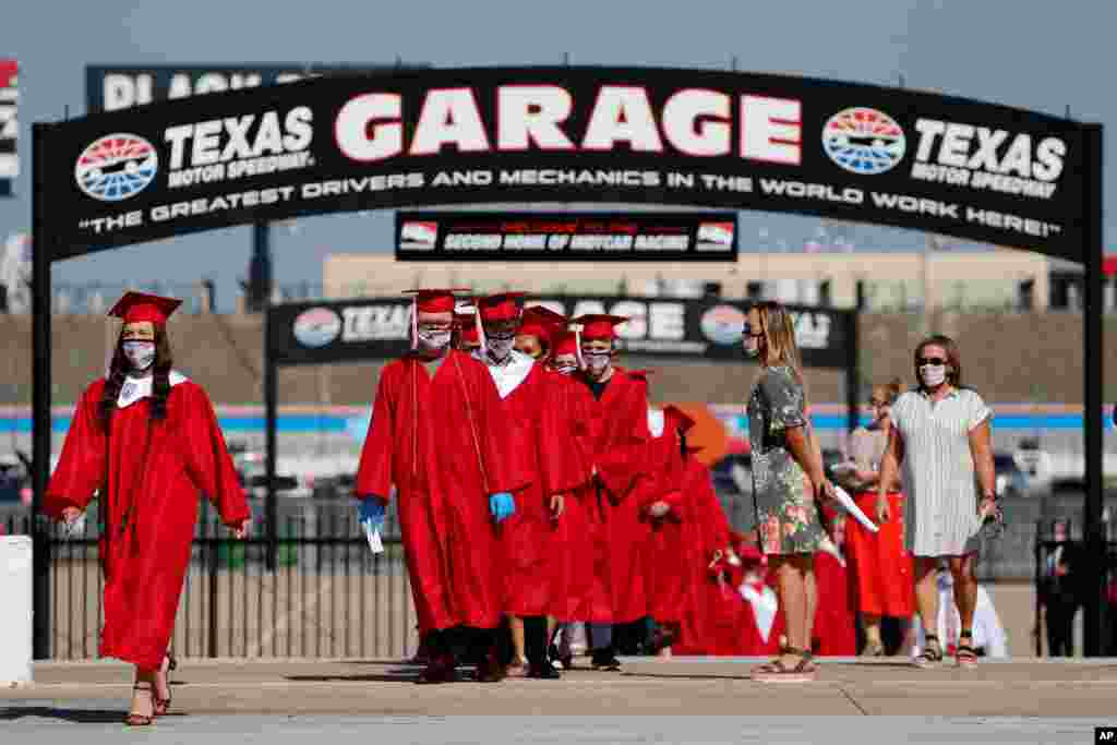 Ponder High School graduates participate in their graduation ceremony at Texas Motor Speedway in Fort Worth, Texas, May 19, 2020. Texas Motor Speedway is hosting 30 socially-distanced high school graduation ceremonies over the next few weeks.