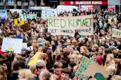 People hold placards during the Global Climate Strike at Raadhuspladsen in Copenhagen, Denmark, Sept. 20, 2019.