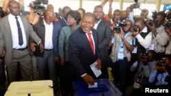 FILE- Frelimo presidential candidate Filipe Nyusi casts his ballot in the general election at a secondary school in Maputo, Oct. 15, 2014. 