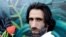 FILE - In this Nov. 19, 2019, photo, Behrouz Boochani, the Kurdish filmmaker, writer and refugee who has documented life inside the Australian offshore immigration camp on Manus Island, poses for a portrait in Christchurch, New Zealand. 
