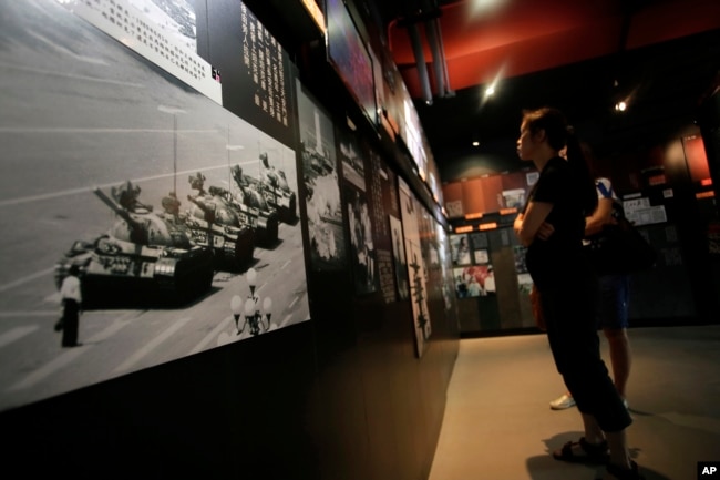 A photograph of Tank Man, the lone protester who stood to block the way of a line of several tanks during the 1989 pro-democracy movement in Beijing, is displayed at the June 4th Museum in Hong Kong, Saturday, June 4, 2016. (AP Photo/Vincent Yu)