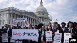 FILE - People gather in Washington to oppose a TikTok ban, March 22, 2023. On Friday, U.S. President-elect Donald Trump asked the Supreme Court to pause the potential ban from going into effect until he is sworn in and his administration can pursue a "political resolution." 